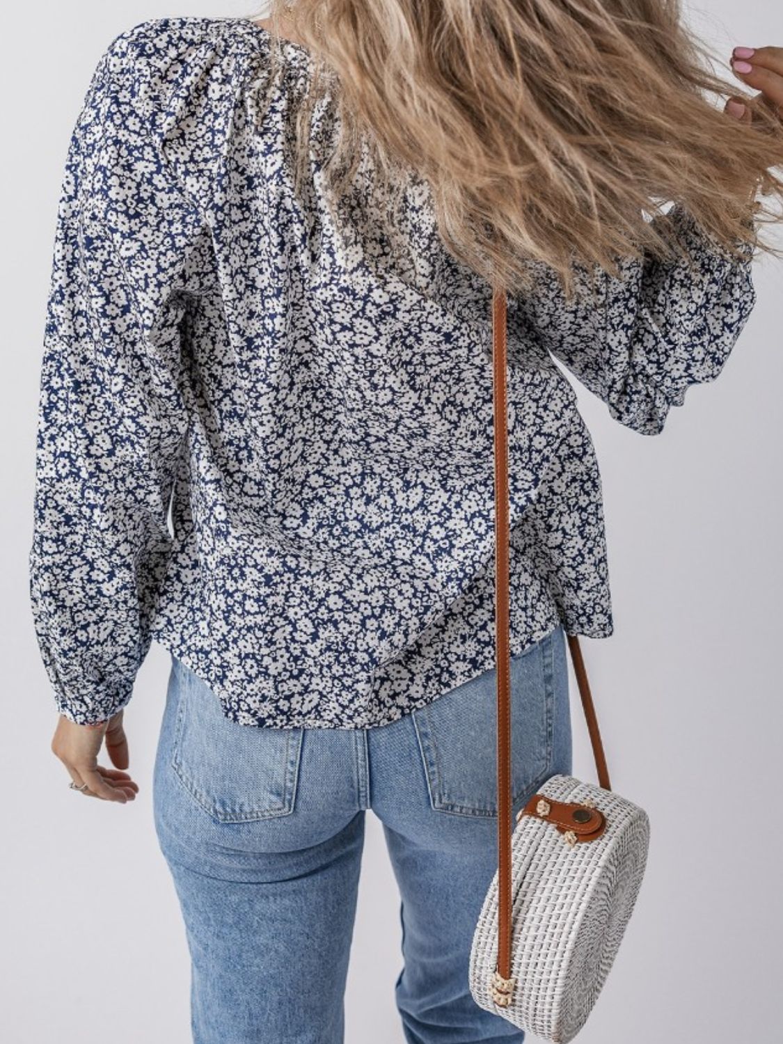 Bloomchic blouse with floral print, long sleeves, and a round neckline.