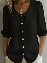 Black button-down shirt with Peter Pan collar and puff sleeves.