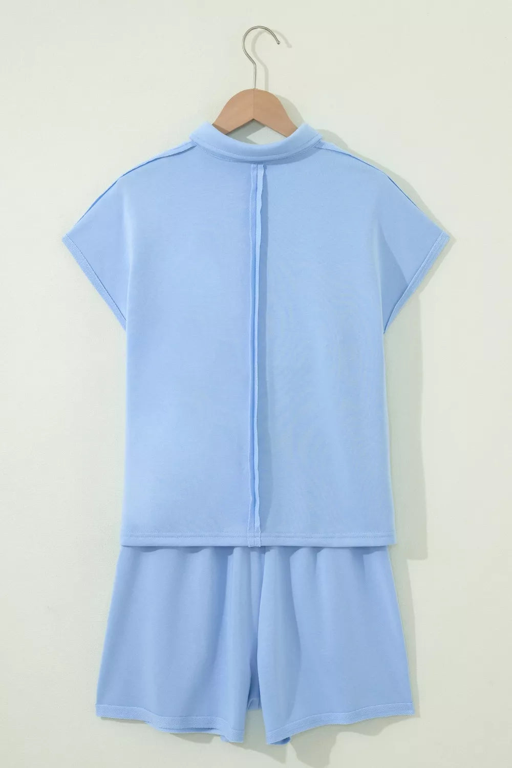 Light blue sleeveless polo shirt and shorts set with contrast stitching detail.