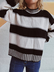 Textured stripe mock neck knit sweater in black and white with ribbed neckline and cuffs.