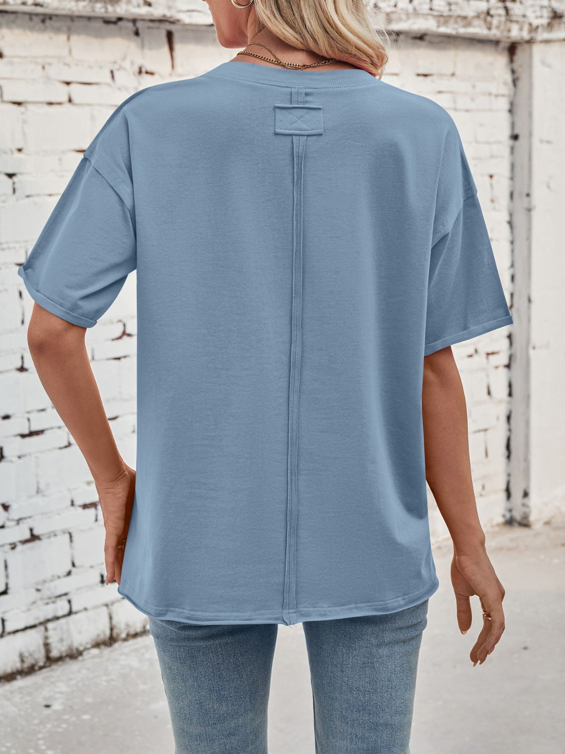 Oversized dusty blue cotton tee with seam detail on back and rolled sleeves.