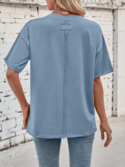 Oversized dusty blue cotton tee with seam detail on back and rolled sleeves.