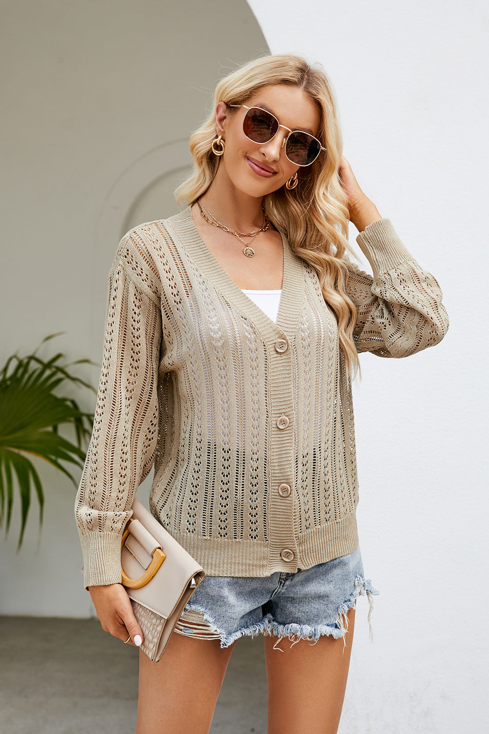 Openwork knit button-down cardigan in khaki with V-neck and long sleeves.