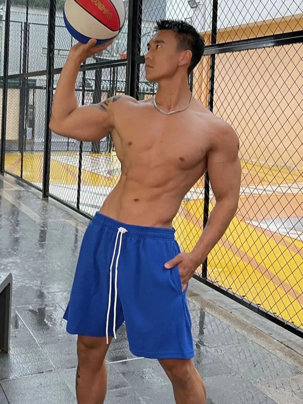 Royal blue athletic drawstring lounge shorts with white ties and pockets.