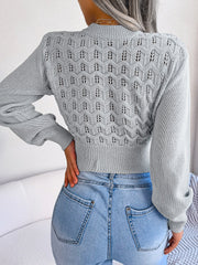 Light gray openwork puff sleeve knit sweater with textured pattern.