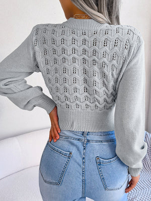 Light gray openwork puff sleeve knit sweater with textured pattern.