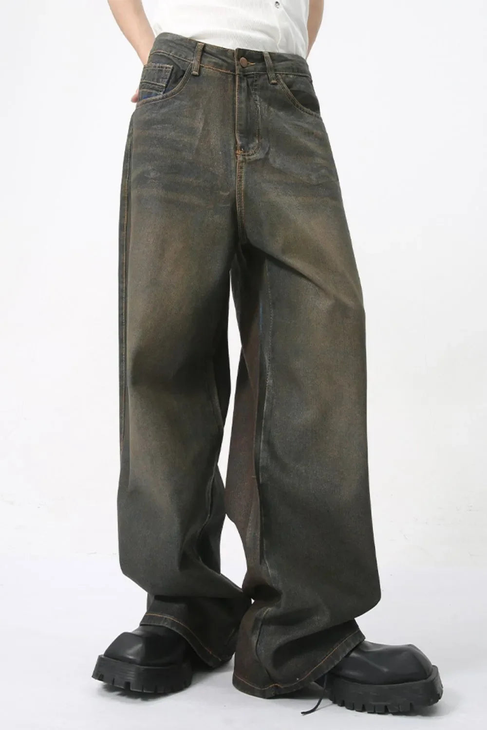 Faded oversized denim trousers in dark wash, featuring a relaxed fit and wide leg.