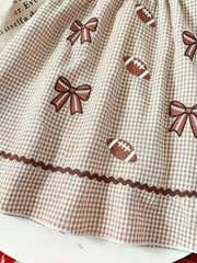 Children's Gingham Football Puff Sleeve Dress in Brown, model styling view