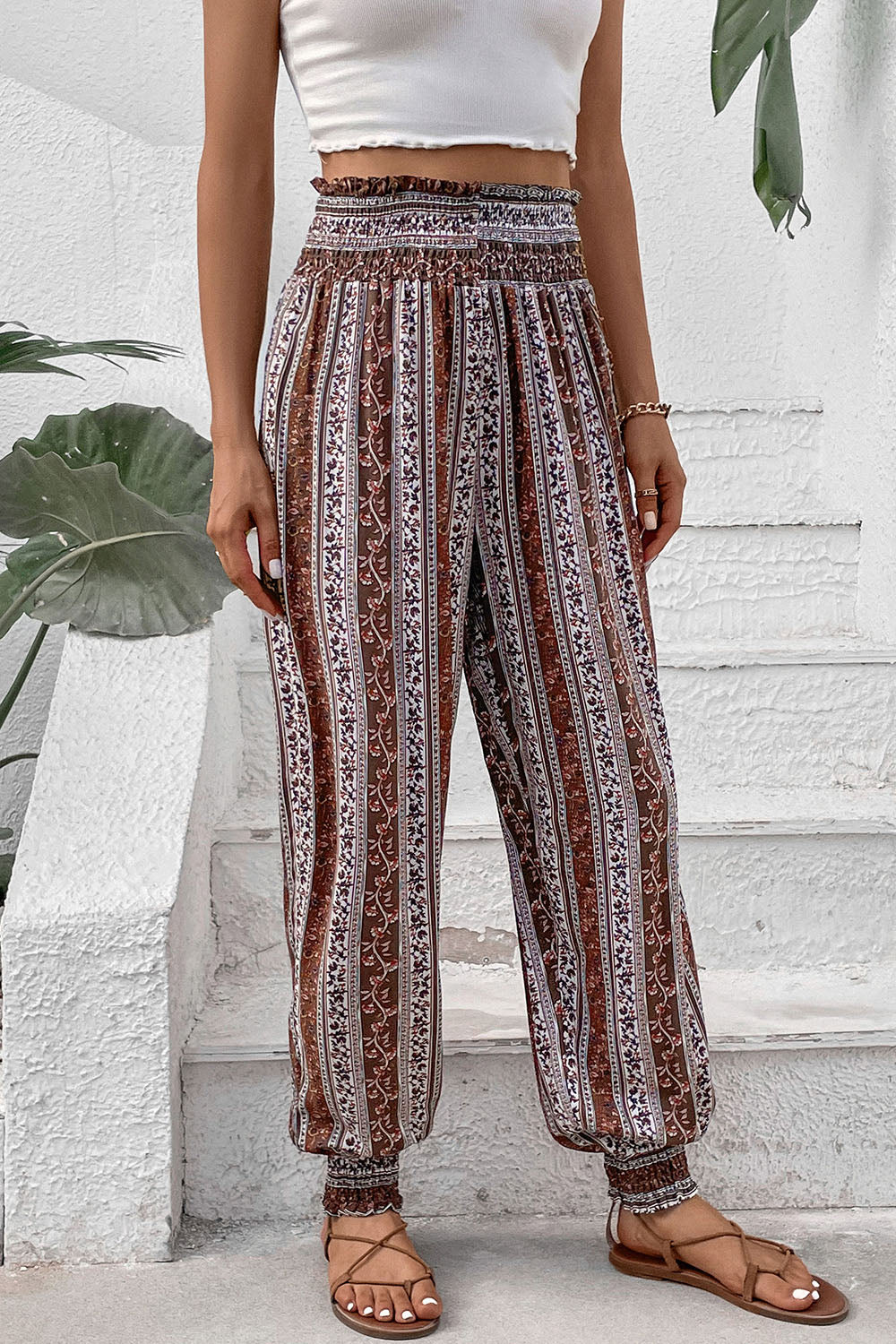 Bohemian smocked waistline trousers in multicolor with a floral stripe pattern and cinched ankles.