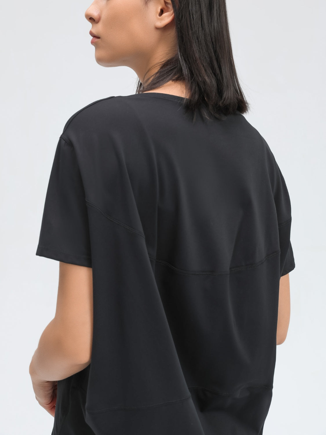 Black relaxed fit performance tee with short sleeves and crew neck.