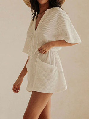 White textured half sleeve cover-up dress with V-neck, drawstring waist, and pockets.