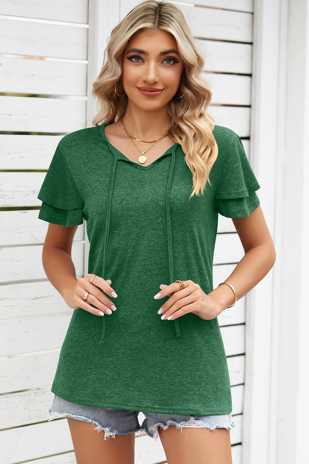 Dark green flutter sleeve henley tee with tie neckline and layered sleeves.