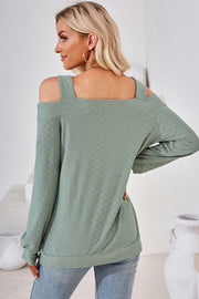 Light green geometric cutout shoulder top with long sleeves and a textured pattern.