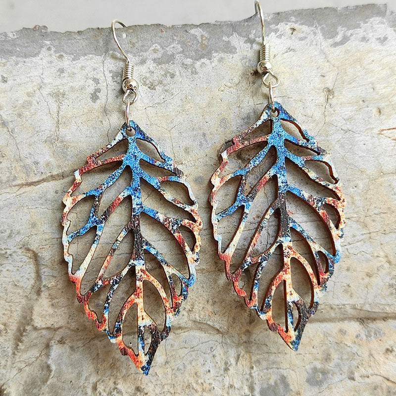 Patina leaf laser-cut drop earrings in Style B with blue, orange, and black abstract pattern.