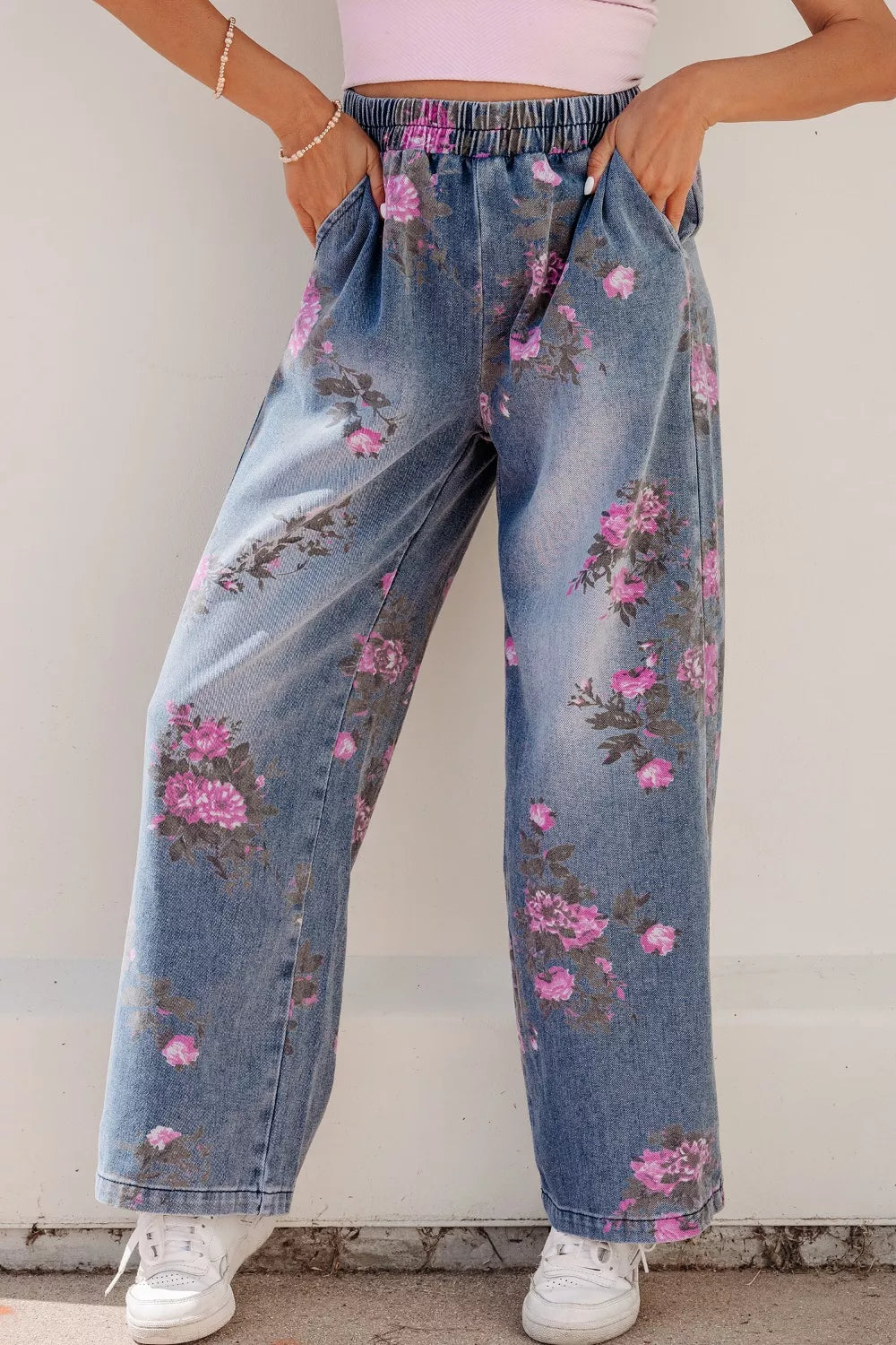 Floral wide-leg denim jeans with elastic waistband and pink floral print.
