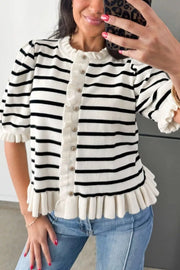 Black and white striped knit cardigan with ruffle trim and buttons, short sleeves.