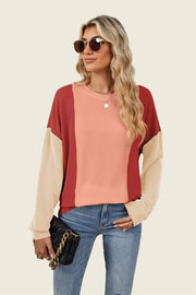 Colorblock waffle knit pullover sweater with crew neck and long sleeves in red, peach, and tan.