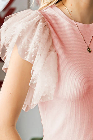 Blush pink ribbed knit blouse with sheer tulle ruffle sleeves with polka dots.