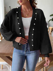 Black bubble sleeve cardigan with pearl buttons and a V-neck.