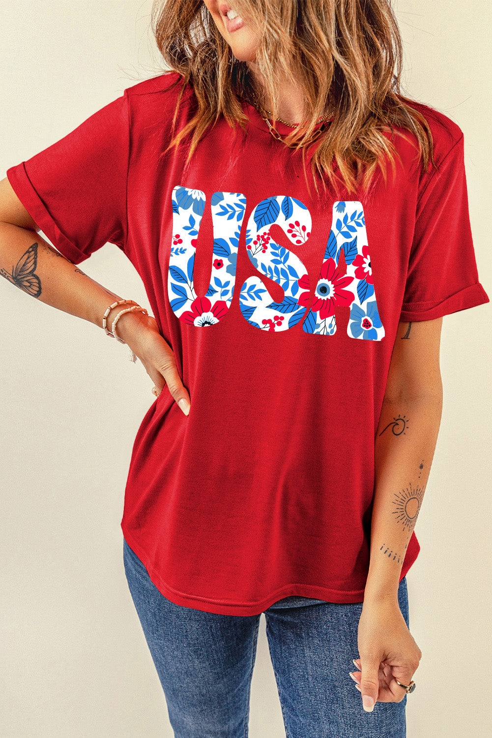 Red t-shirt with floral USA graphic, short sleeves, and rolled cuffs.