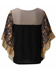 Textured panel blouse in black with floral print flutter sleeves and ruffled trim.