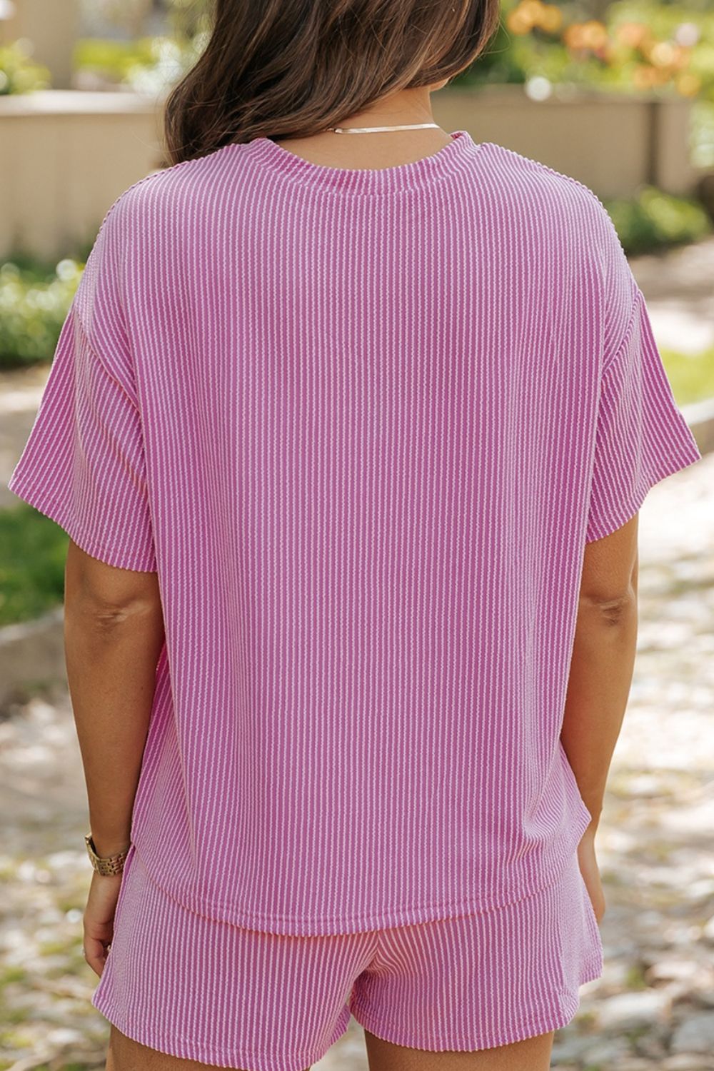 Pink striped loungewear set with short sleeves and shorts.