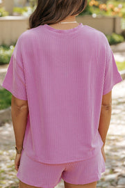 Pink striped loungewear set with short sleeves and shorts.