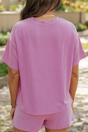 Pink striped loungewear set with short sleeves and shorts.