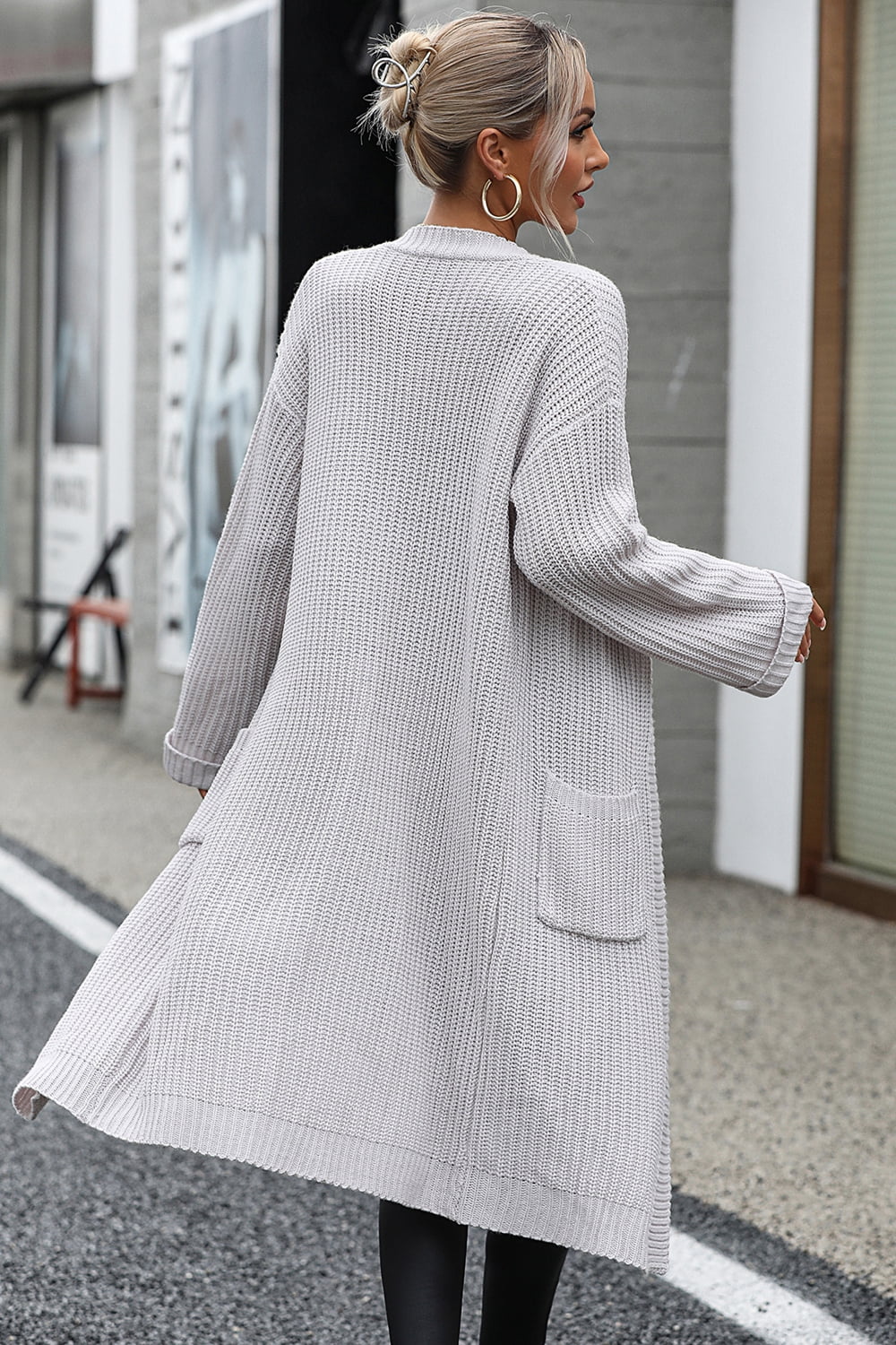 Light gray longline knit cardigan with pockets and ribbed trim.
