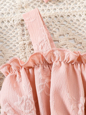 Pink floral embossed baby one-piece with ruffles and a headband.