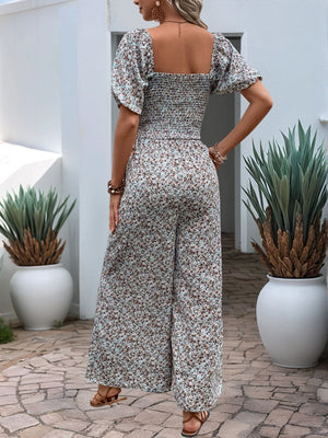 Floral smocked bodice wide leg jumpsuit with puff sleeves in a dusty pink floral print.