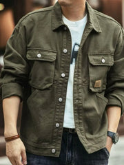 Moss green washed cotton chore jacket with four front pockets and button closure.