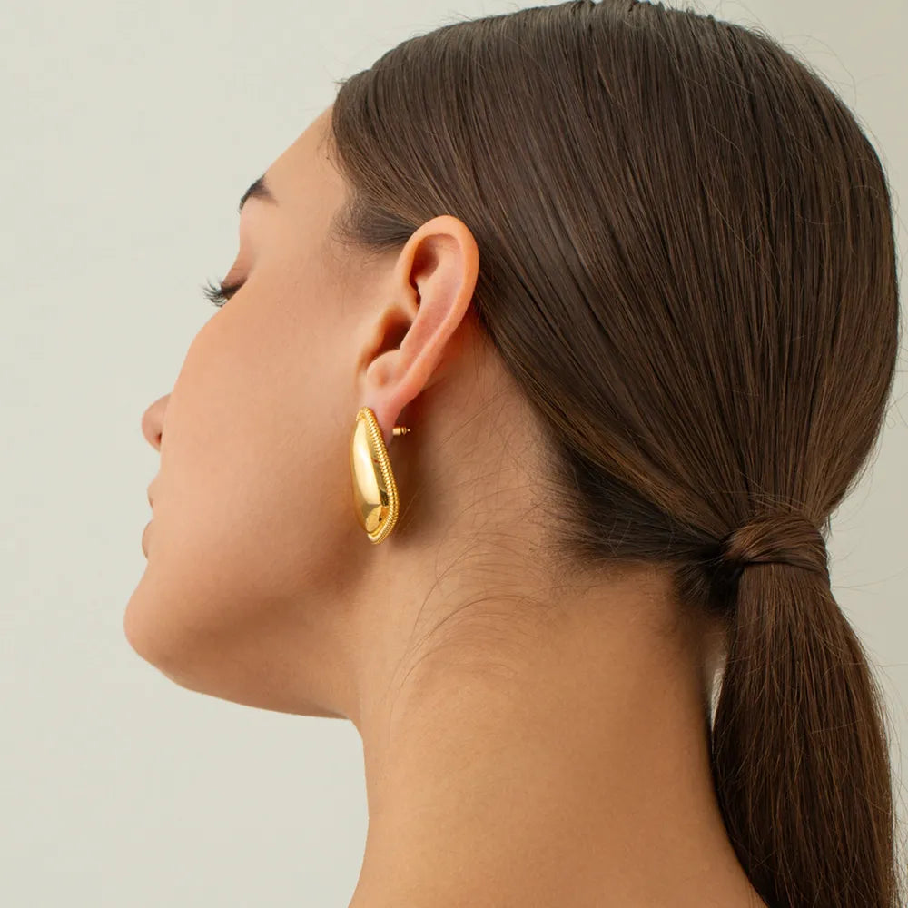 Sculpted gold vermeil oval hoop earrings with beaded edge detail.