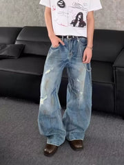 Distressed wide-leg denim jeans with chain detail and light wash.