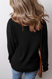 Black ribbed knit long sleeve top with a relaxed fit.
