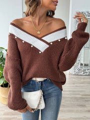 Brown ribbed knit sweater with pearl trim and V-neck detail.
