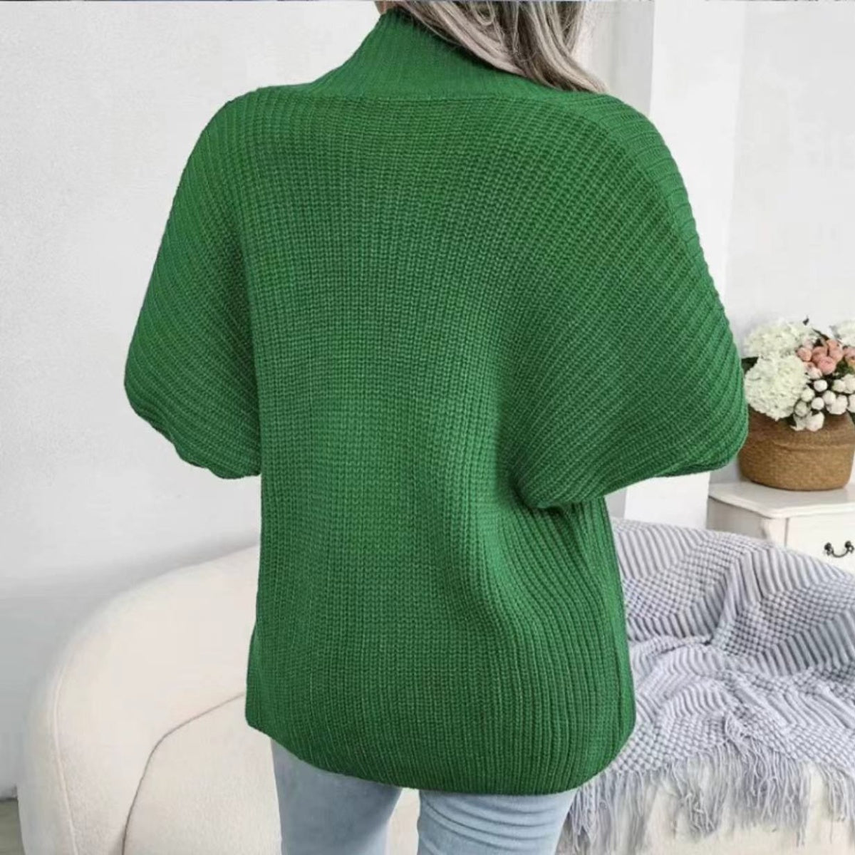 Green chunky knit dolman sleeve cardigan with a high neck and ribbed texture.
