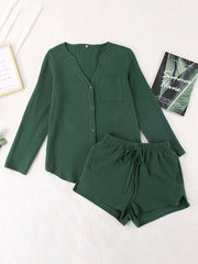 Textured cotton pajama set in dark green with button-up top and drawstring shorts.