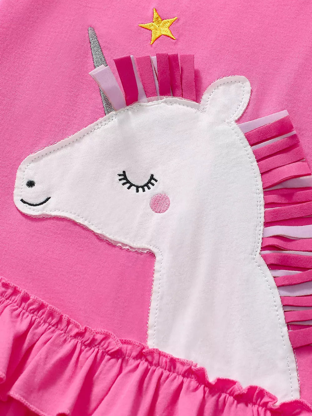 Pink toddler dress with unicorn applique, ruffled hem, and star detail.
