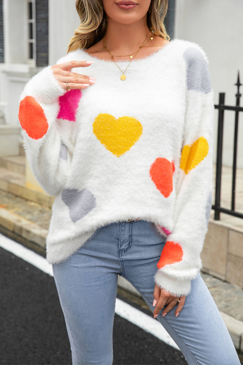 Fluffy white knit sweater with colorful heart pattern, crew neck, long sleeves.