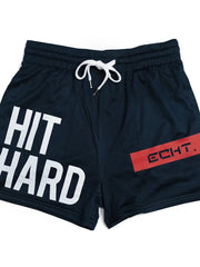 Navy mesh training shorts with white "HIT HARD" graphic and red "ECHT." logo detail.