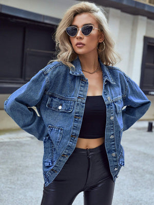 Oversized medium wash denim trucker jacket with buttoned chest pockets and collar.