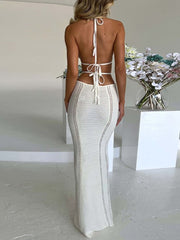 White backless knitted maxi dress with cutouts and halter neck.