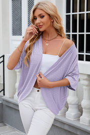 Lavender open-front crochet kimono sleeve top with a circular pattern, styled with a white cami and white pants.