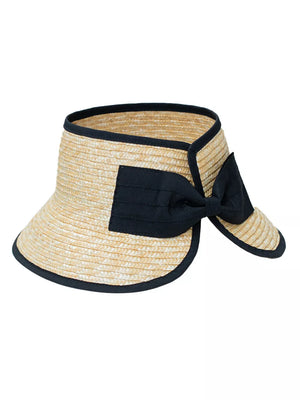 Straw visor hat in natural with black trim and bow detail.