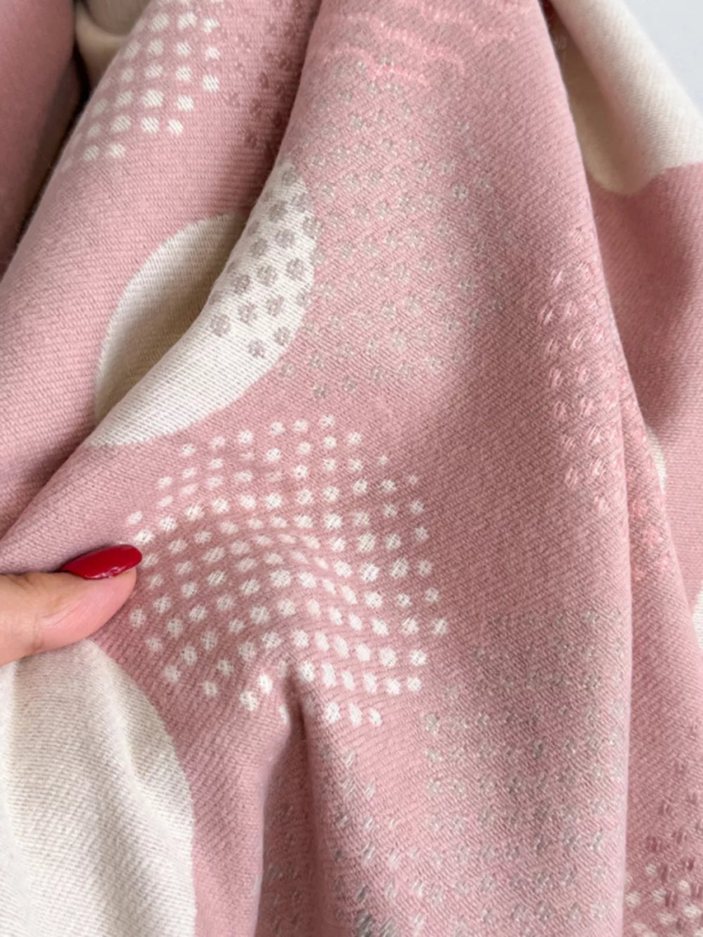 Dusty pink textured scarf with white polka dot pattern and subtle metallic threads