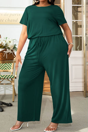 Forest green relaxed fit jumpsuit with drawstring waist and wide legs.