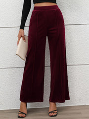 Burgundy velvet palazzo trousers with seam detail and wide leg