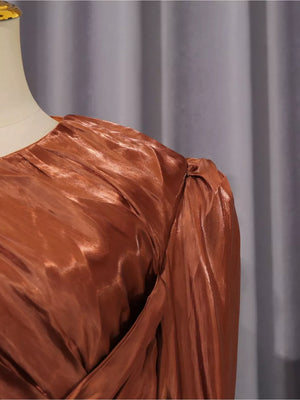 Brown ruched bodice maxi dress with twisted draped detail and puffed sleeves.