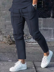 Navy casual drawstring sweatpants with pockets and contrast stitching.